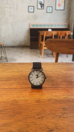 Close-up of clock on table