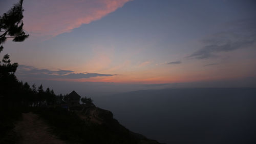 Scenic view of silhouette mountains against sky during sunset