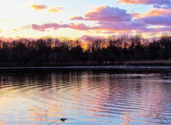 Scenic view of lake against sky at sunset