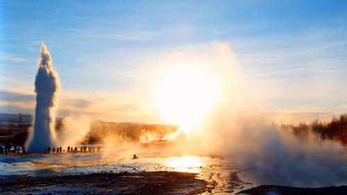 Smoke emitting from against sky during sunset
