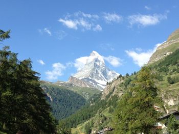 Scenic view of mountains against blue sky