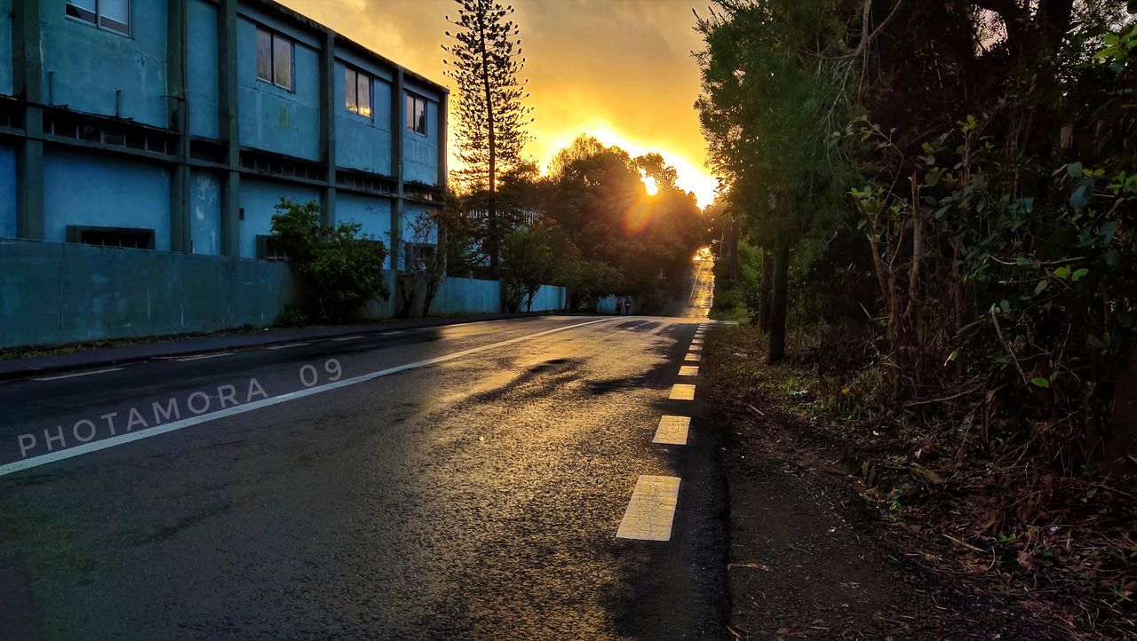 road, sunset, light, evening, architecture, night, sky, urban area, nature, city, plant, built structure, transportation, building exterior, darkness, street, tree, no people, sign, cloud, building, outdoors, infrastructure, dusk, reflection, lane, lens flare, twilight, house