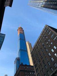 Low angle view of modern buildings against blue sky