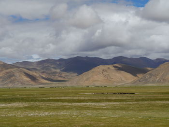 Countryside landscape against mountain range