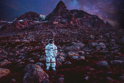 Rock formation on mountain against sky at night