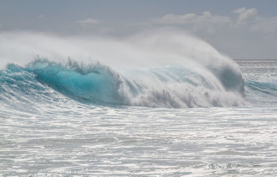 Scenic view of sea waves against sky