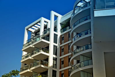 Low angle view of building against clear blue sky