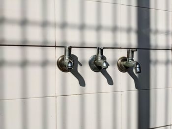 Close-up of metal hanging against wall