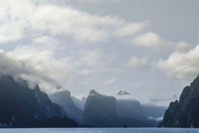 Scenic view of sea and mountains against sky