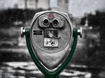 Close-up of coin-operated binoculars against blurred background