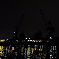 View of illuminated harbor at night