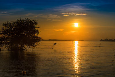 Scenic view of sea against orange sky