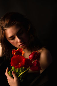 Midsection of woman holding rose bouquet