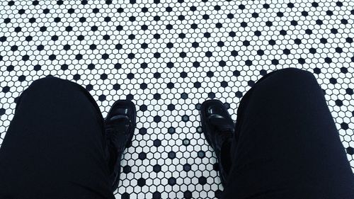 Close-up of woman standing on tiled floor