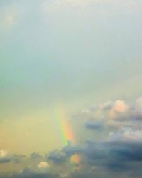 Low angle view of rainbow against sky during sunset