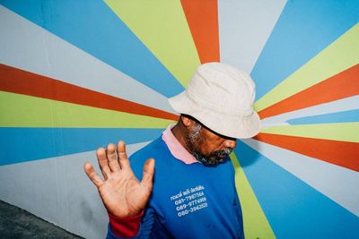 High angle view of man standing against blue wall