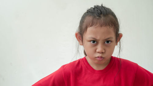 Portrait of cute girl against white background