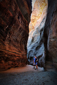 Rear view of man walking in cave