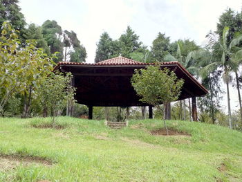 Gazebo on grass against sky