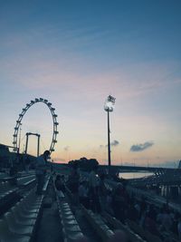 Ferris wheel against sky at sunset