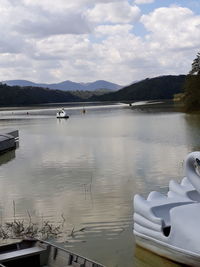 View of boats in lake against sky