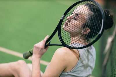 Midsection of woman playing tennis