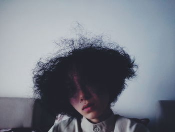 Young woman with curly hair at home