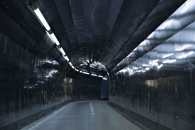 Empty subway along tiled walls