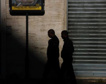 Side view of man standing on street