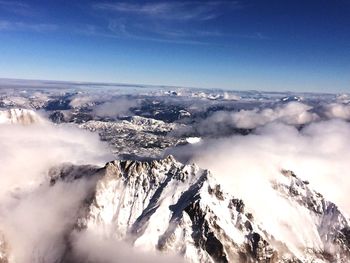 Scenic view of mountain range against cloudy sky