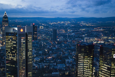 Illuminated cityscape against sky