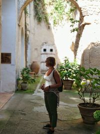 Full length of woman standing against building