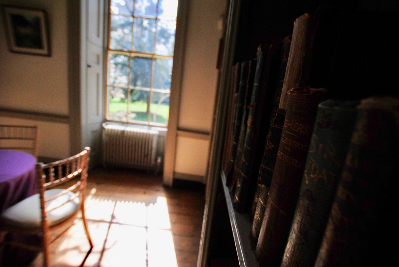 CLOSE-UP OF BOOKS ON TABLE AT HOME