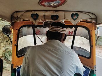 Rear view of man in car