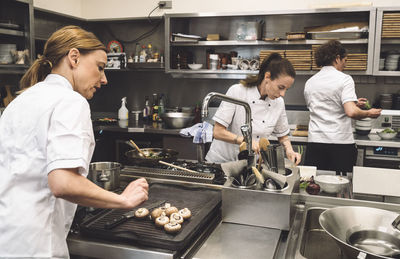 Female chefs preparing food in commercial kitchen at restaurant