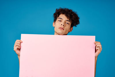 Portrait of boy against blue background