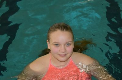 Portrait of a smiling woman swimming in pool