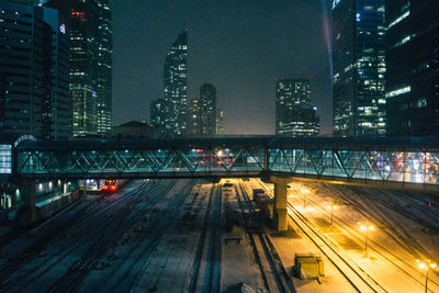 Illuminated cityscape against sky at night