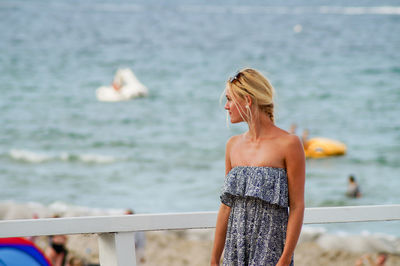 Rear view of woman standing in water