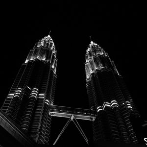 Low angle view of skyscrapers lit up at night