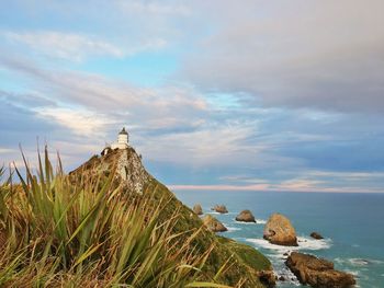 Rocks by sea against sky