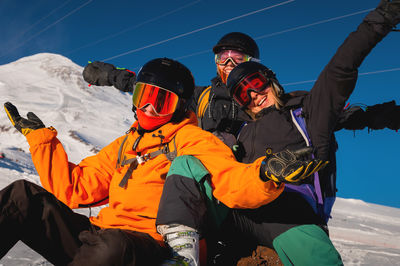 Group of young people enjoy their vacation in the mountains in winter. hipsters in ski clothes happy