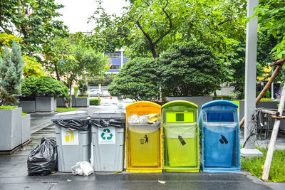 Garbage bin by trees in city