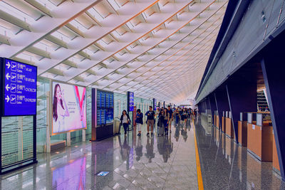 Group of people walking on tiled floor