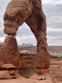 View of rock formation against cloudy sky