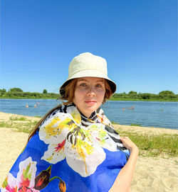 Portrait of woman standing at beach