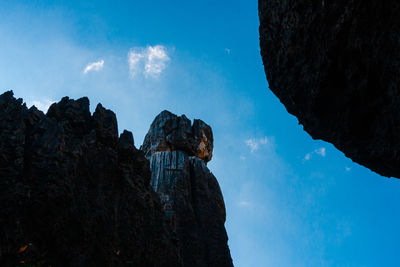 Low angle view of rock formation against sky