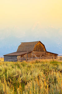 Barn on field against sky