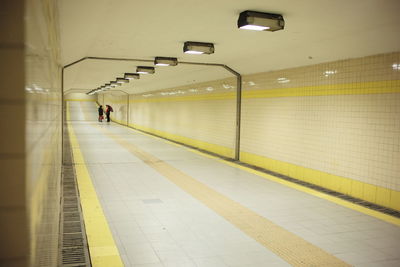 People standing in illuminated subway