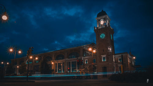 Low angle view of illuminated buildings against sky at night